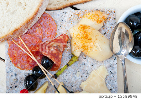 mix cold cut on a stone with fresh pears 15589948