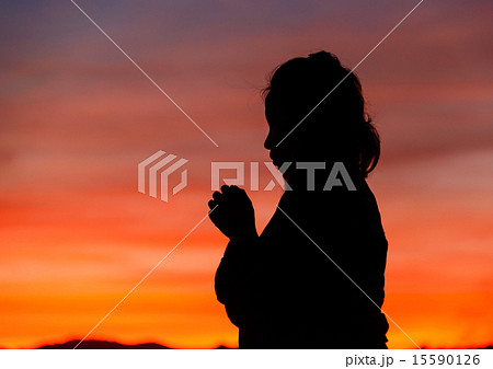 Silhouette of a Christian woman is praying Silhouette of a Christian woman is praying 15590126