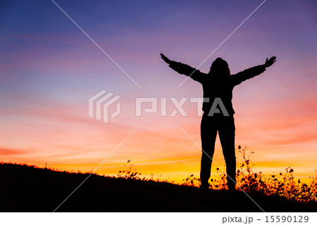 Silhouette of a Christian woman is praying  15590129