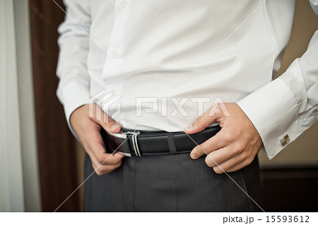 The man corrects a belt. The man corrects a belt. 15593612