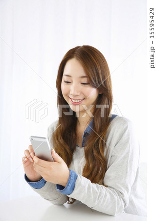 スマホを使う若い女性 15595429
