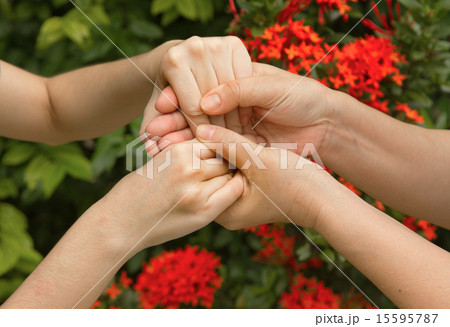 Hands of mother and daughter holding  together 15595787