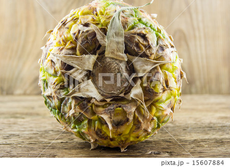 Ripe tasty pineapple lie on a wooden background Ripe tasty pineapple lie on a wooden background 15607884