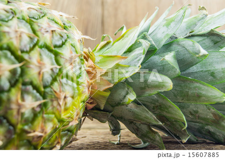 Ripe tasty pineapple lie on a wooden background Ripe tasty pineapple lie on a wooden background 15607885