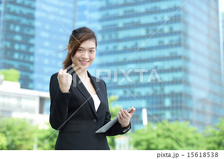 Chinese businesswoman using iPad celebrate success Chinese businesswoman using iPad celebrate success 15618538
