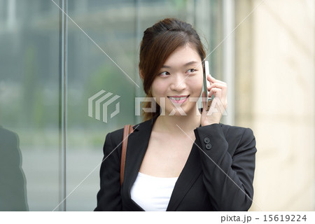 Chinese businesswoman making business call outdoor 15619224