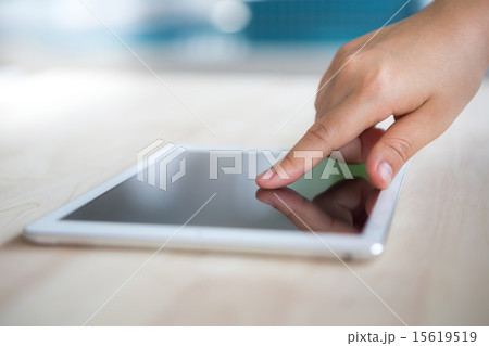 Woman hand touch  white tablet with blank screen 15619519
