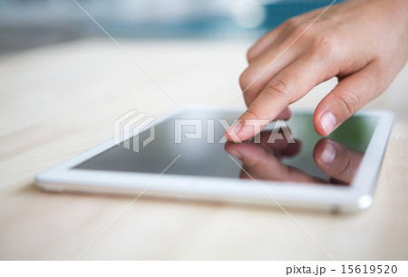 Woman hand touch  white tablet with blank screen 15619520