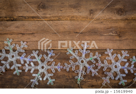 snowflakes lights on wood background 15619940
