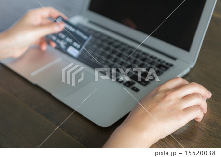 Hands holding a credit card and using laptop Hands holding a credit card and using laptop 15620038