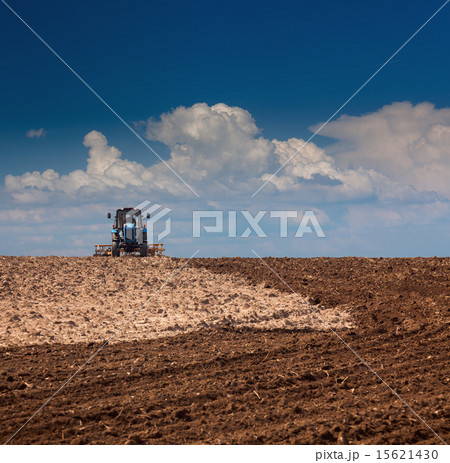 Agricultural Lanscape - Tractor working on a field Agricultural Lanscape - Tractor working on a field 15621430