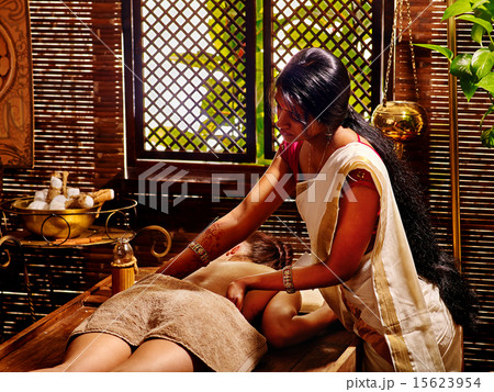 Woman having Ayurvedic spa treatment. 15623954