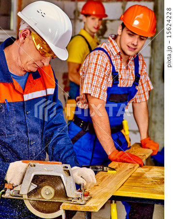 Group people  builder with circular saw . 15624228