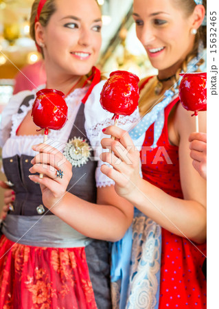 Friends eating candy apples at Oktoberfest 15632465