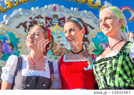 Friends visiting Bavarian fair having fun 15632467