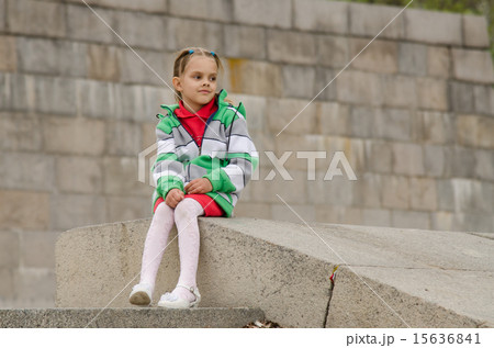 girl looks into distance while sitting a granite embankment on ramp girl looks into distance while sitting a granite embankment on ramp 15636841