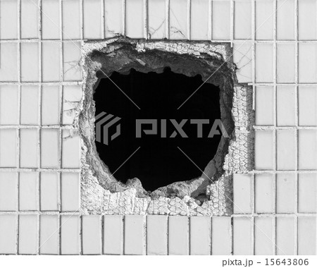 Hole on the old white wall 15643806