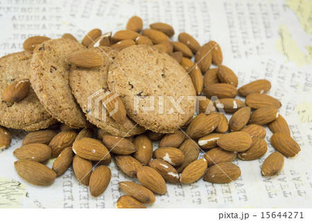 Table covered with raw almonds and cookies Table covered with raw almonds and cookies 15644271