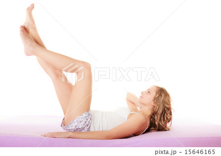 Woman in bed with legs in air Woman in bed with legs in air 15646165