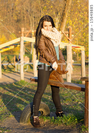 beautiful and sexy girl sitting on bench outdoors 15649885