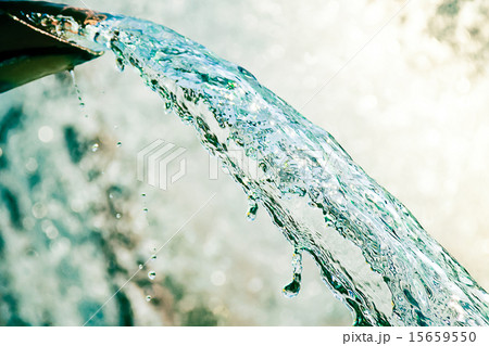 Close up of water gushing out of the pipe 15659550