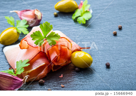Curled Slices of Delicious Prosciutto with parsley 15666940