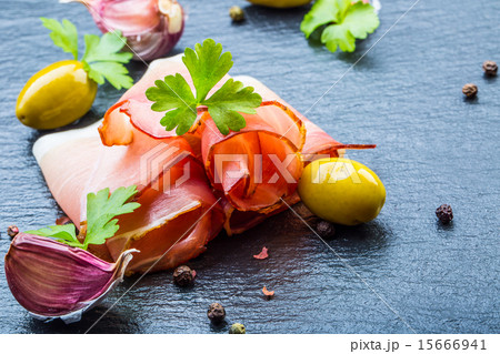 Curled Slices of Delicious Prosciutto with parsley 15666941