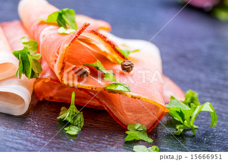 Curled Slices of Delicious Prosciutto with parsley 15666951
