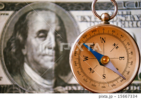 Vintage Compass Standing In Front of 100 USD Bill Vintage Compass Standing In Front of 100 USD Bill 15667334
