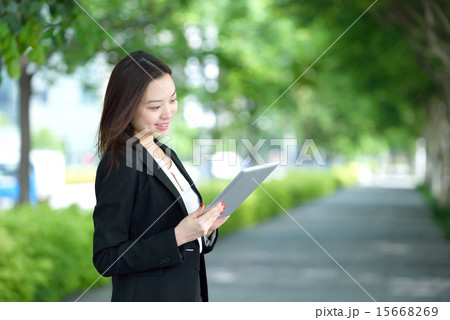 Young Chinese businesswoman using iPad Young Chinese businesswoman using iPad 15668269