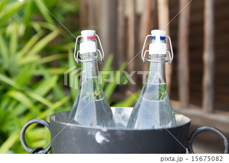 couple of water bottles in ice bucket at hotel 15675082