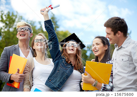 group of smiling students with diploma and folders 15675600