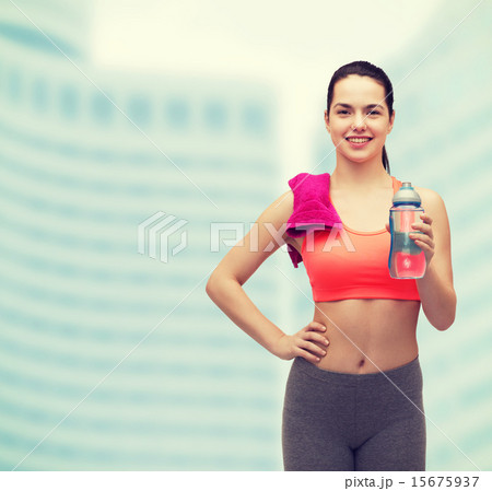 sporty woman with towel and water bottle 15675937