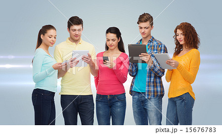 group of teenagers with smartphones and tablet pc group of teenagers with smartphones and tablet pc 15676783