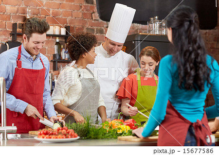happy friends and chef cook cooking in kitchen 15677586