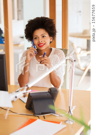 businesswoman calling on smartphone at office 15677659