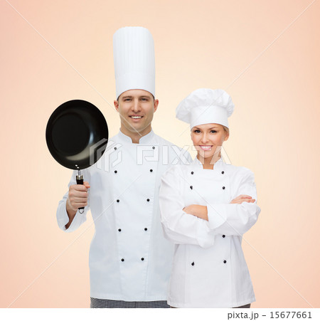 happy chefs or cooks couple with frying pan happy chefs or cooks couple with frying pan 15677661