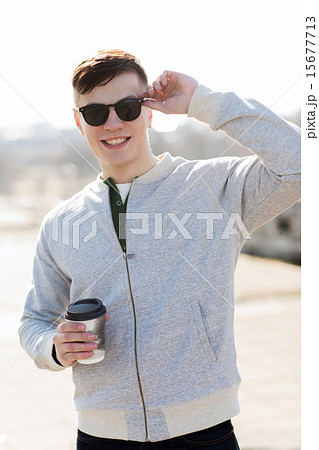 smiling young man or boy drinking coffee smiling young man or boy drinking coffee 15677713