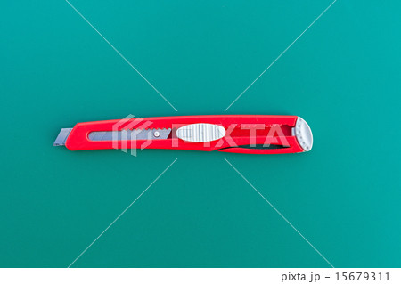 A ruler and cutter on green cutting mat 15679311