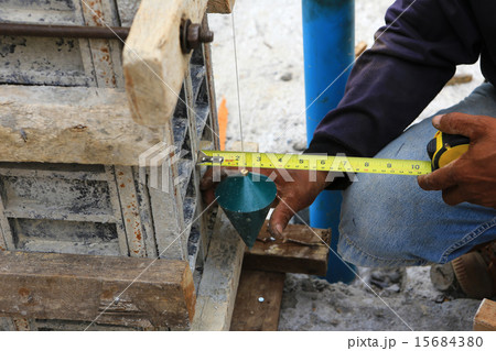 labor man using a plumb bob for check . 15684380