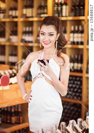 Beautiful asian woman with a glass of wine Beautiful asian woman with a glass of wine 15688617