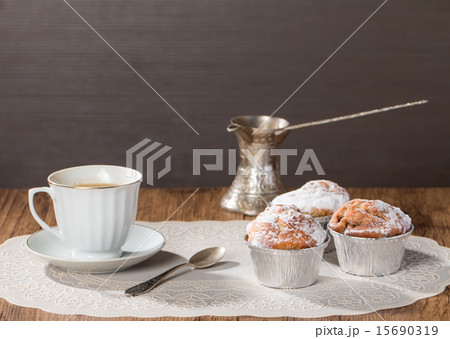 Cup of coffee with tasty muffins and turk Cup of coffee with tasty muffins and turk 15690319