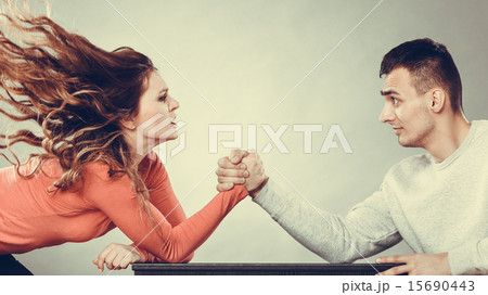 Arm wrestling challenge between young couple Arm wrestling challenge between young couple 15690443
