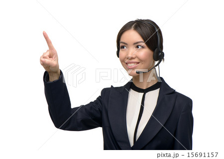 Asian call center female operator pointing at something Asian call center female operator pointing at something 15691157