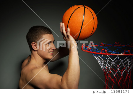 Basketball athlete throwing ball into the basket Basketball athlete throwing ball into the basket 15691175