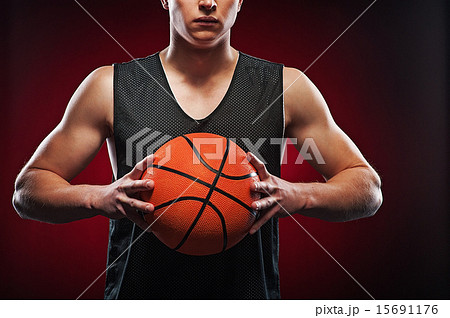 Male basketball athlete gripping the ball Male basketball athlete gripping the ball 15691176