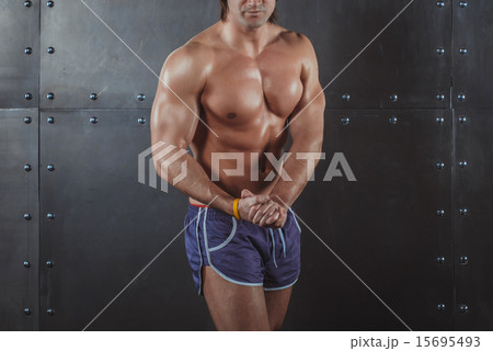 Bodybuilder posing Strong Athletic Man Fitness Model Torso showing big muscles fitness healthy 15695493