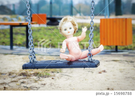 Old abandoned doll on a swing Old abandoned doll on a swing 15698788