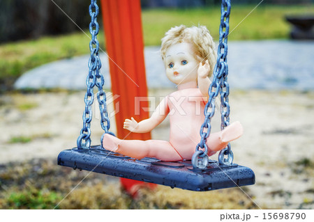 Old abandoned doll on a swing at outdoors  15698790