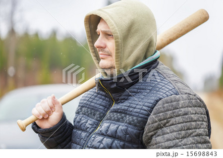 Man with a baseball bat near car Man with a baseball bat near car 15698843
